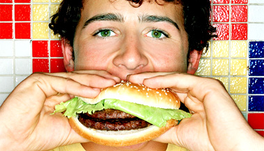 A man eats a hamburger