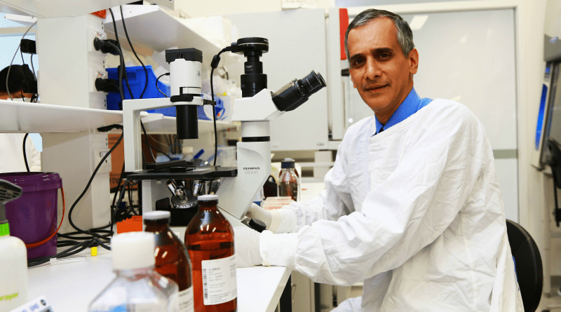 Jacob George in a lab and coat