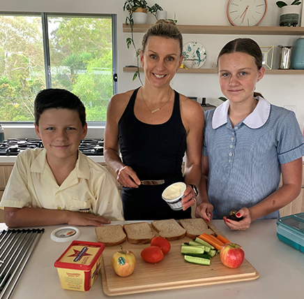 Louise Sutherland with her two children preparing healthy sandwiches. 