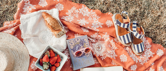 Picnic mat with various items on it. 