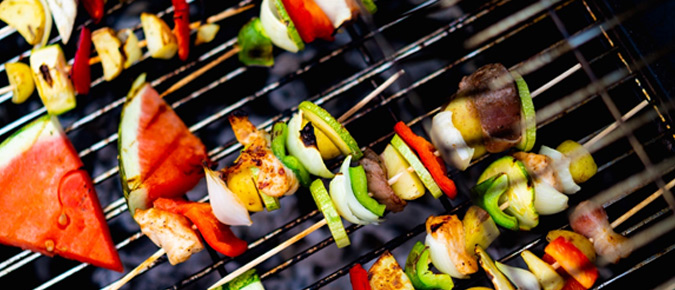 Various foods being cooked on a barbecue.