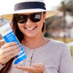 Woman applying sunscreen.