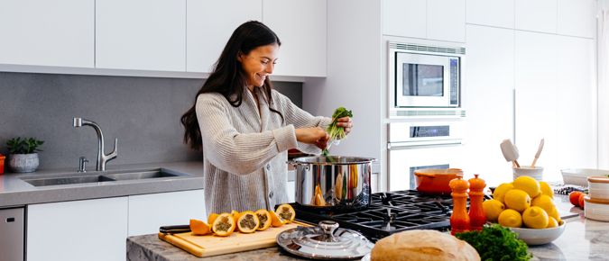 Woman preparing healthy food in the kitchen. 