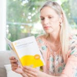 A woman reads a cancer information booklet