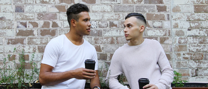 Two men holding coffee