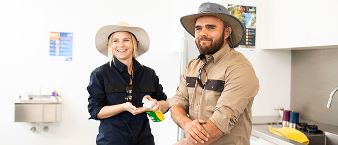 Two people applying sunscreen.