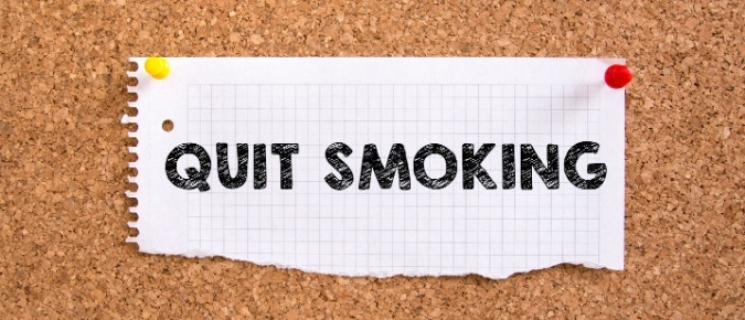 A piece of paper with the words 'Quit smoking' on it.