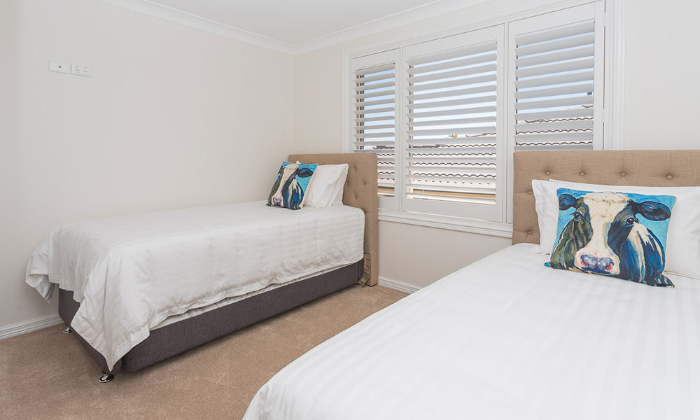 Two single beds in a clean bedroom