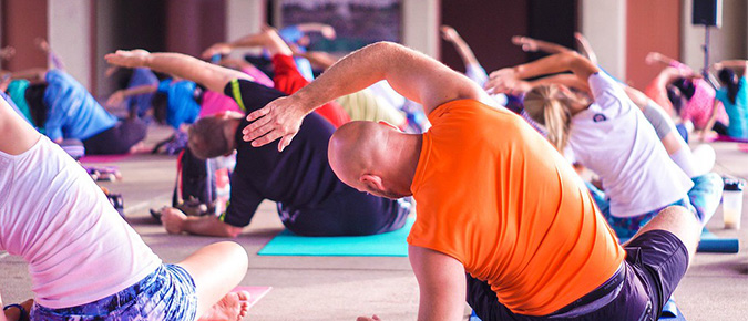 Group of people stretching at the gym.