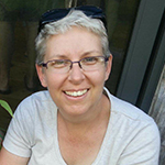 Woman with short hair smiling.