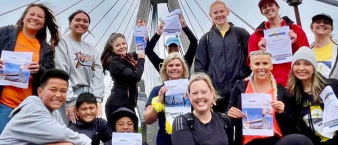 Group of people smiling and holding up certificates.