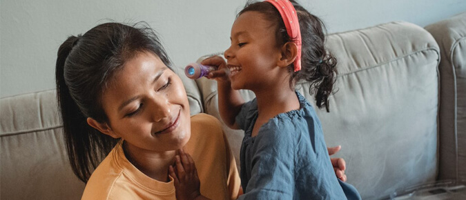 Little girl playing with her mother.