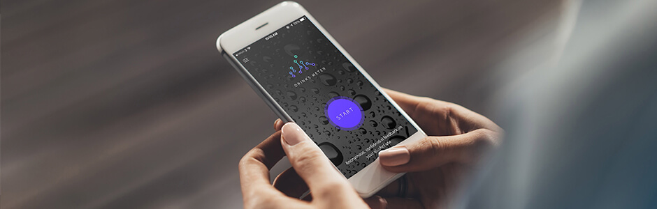 Hands holding phone showing the Drinks Meter App.