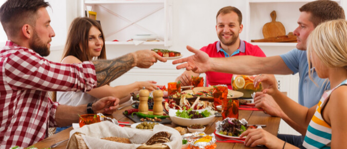 Group of people eating food.