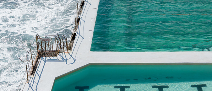 A swimming pool next to the ocean.