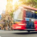 Red bus in the city.