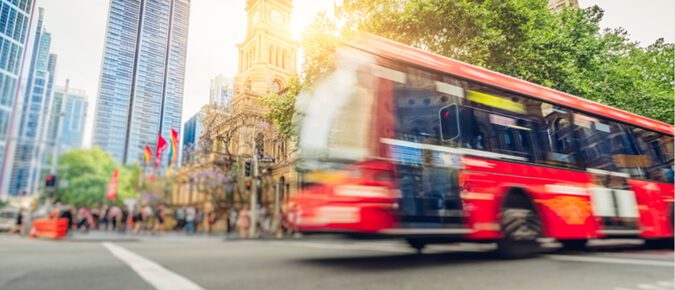 Red bus in the city.