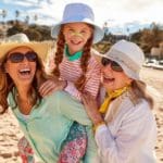 mother daughter and grandma at the beach