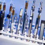 vapes and e-cigarettes in a scientific test tube rack