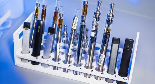 vapes and e-cigarettes in a scientific test tube rack