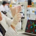 cancer researchers in lab coats