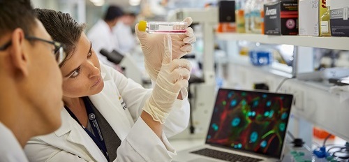 cancer researchers in lab coats 