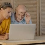 man and woman looking at computer