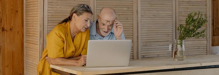 man and woman looking at computer