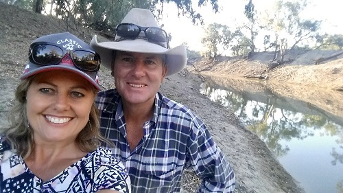 Wayne McDonell smiling near creek with wife Lisa