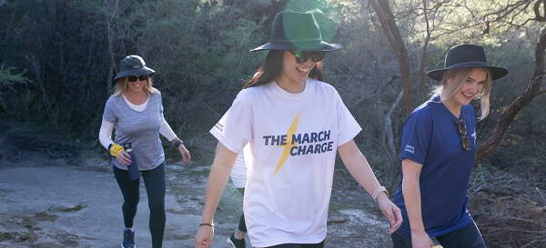 3 girls smiling doing the cancer council the march charge