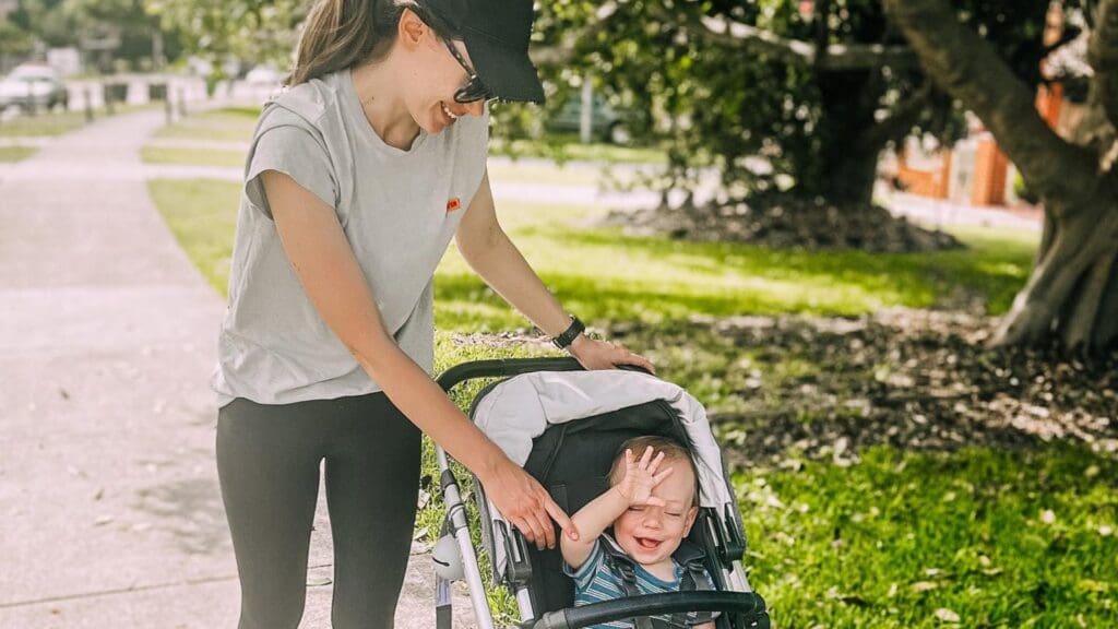 Amber Laidler with her baby in a pram, walking for The March Charge.