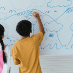 kids drawing on white board at home