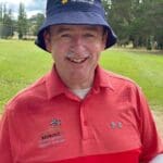 tony wearing sunsmart hat smiling at golf course
