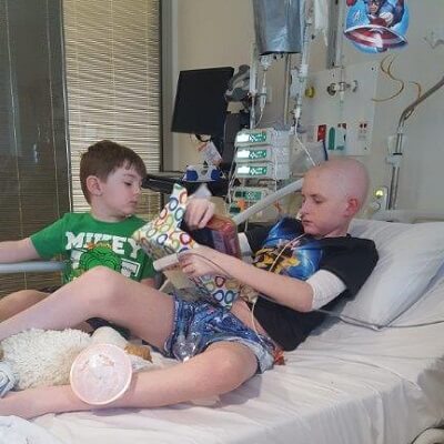 Kane is visited in hospital by a friend