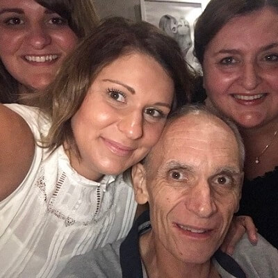 John, a cancer patient, is surrounded by his loving family.