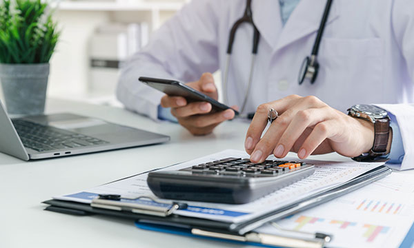 A doctor using a calculator