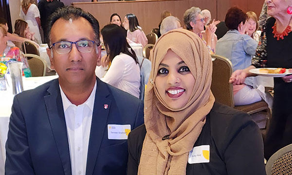 A couple sit at a table at a fundraising event
