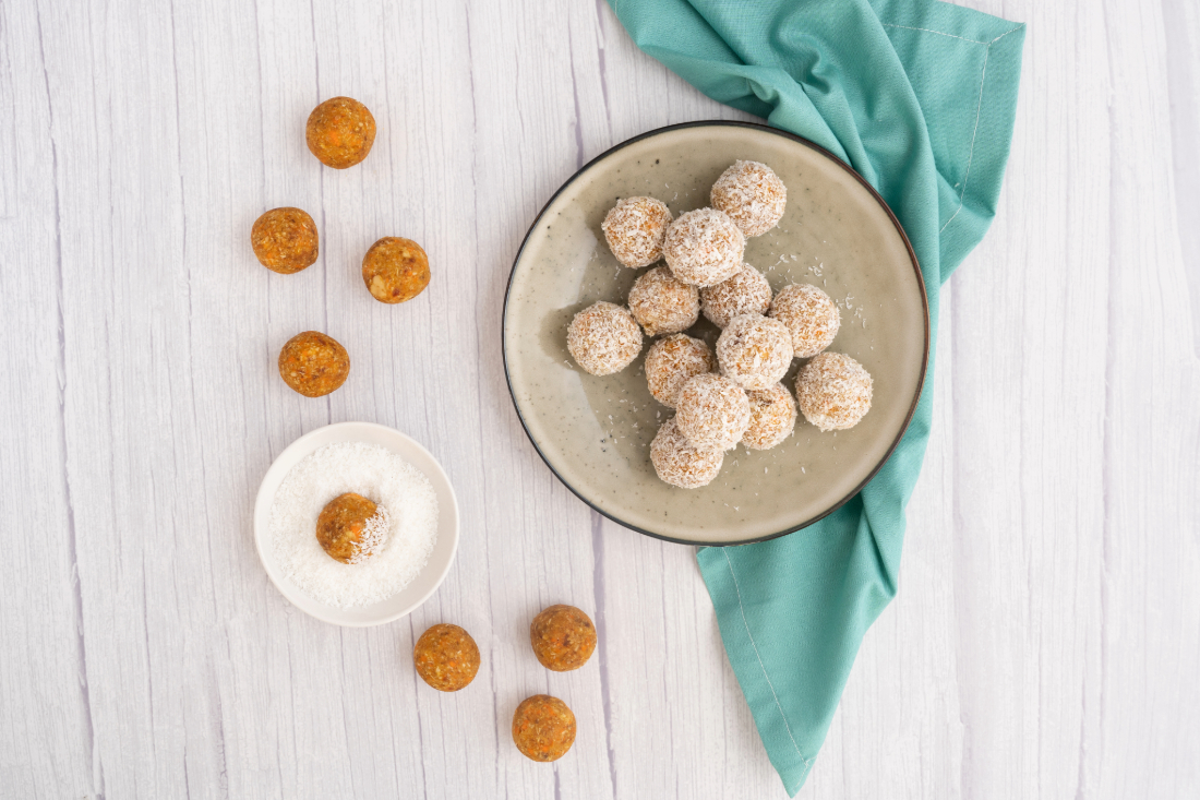 A photo of carrot cake bliss balls, on a serving plate.