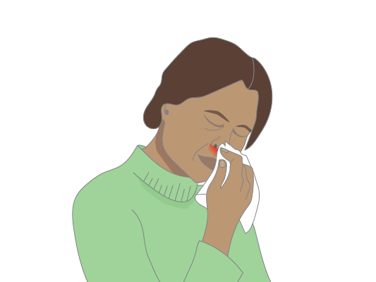 Women with a cold blowing her nose in a tissue.