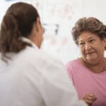 Woman talking to her GP