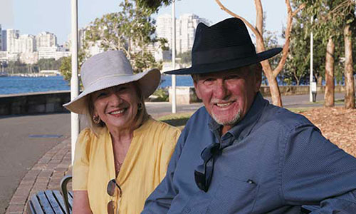 John and Jo smiling in a park
