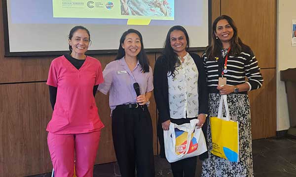 Four women at a public event about cervical screening